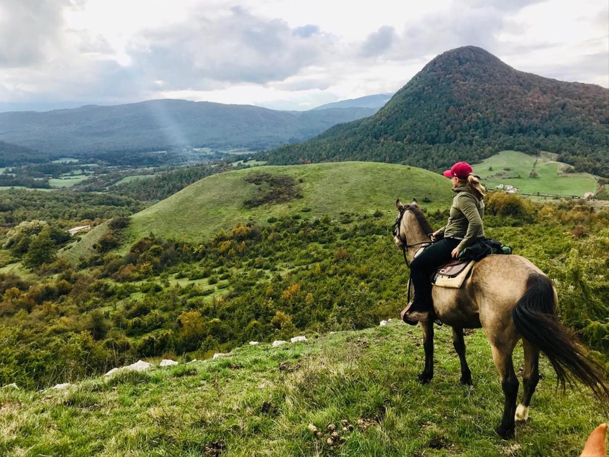 A rider on horseback enjoys the scenery of Italy