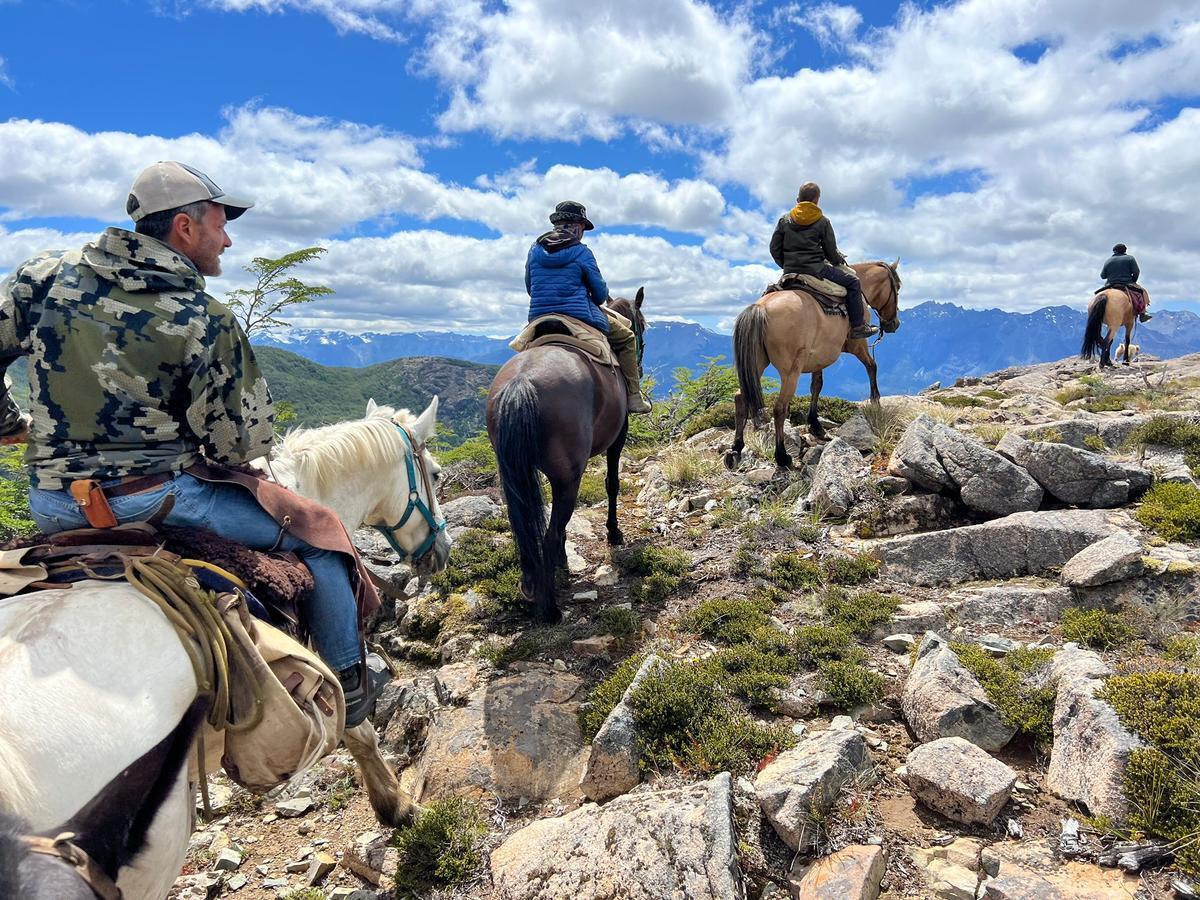 Group of tourists riding horses in the mountains of Patagonia