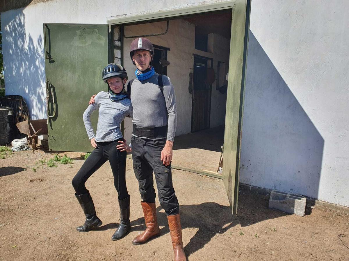 Father and daughter in horse riding gear