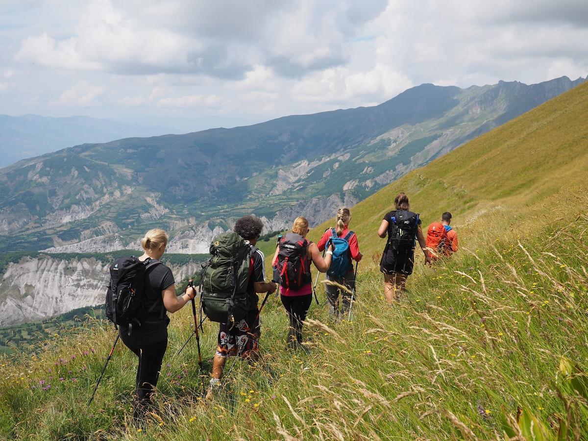 Group of Hikers is Traveling Through the Mountains of Europe